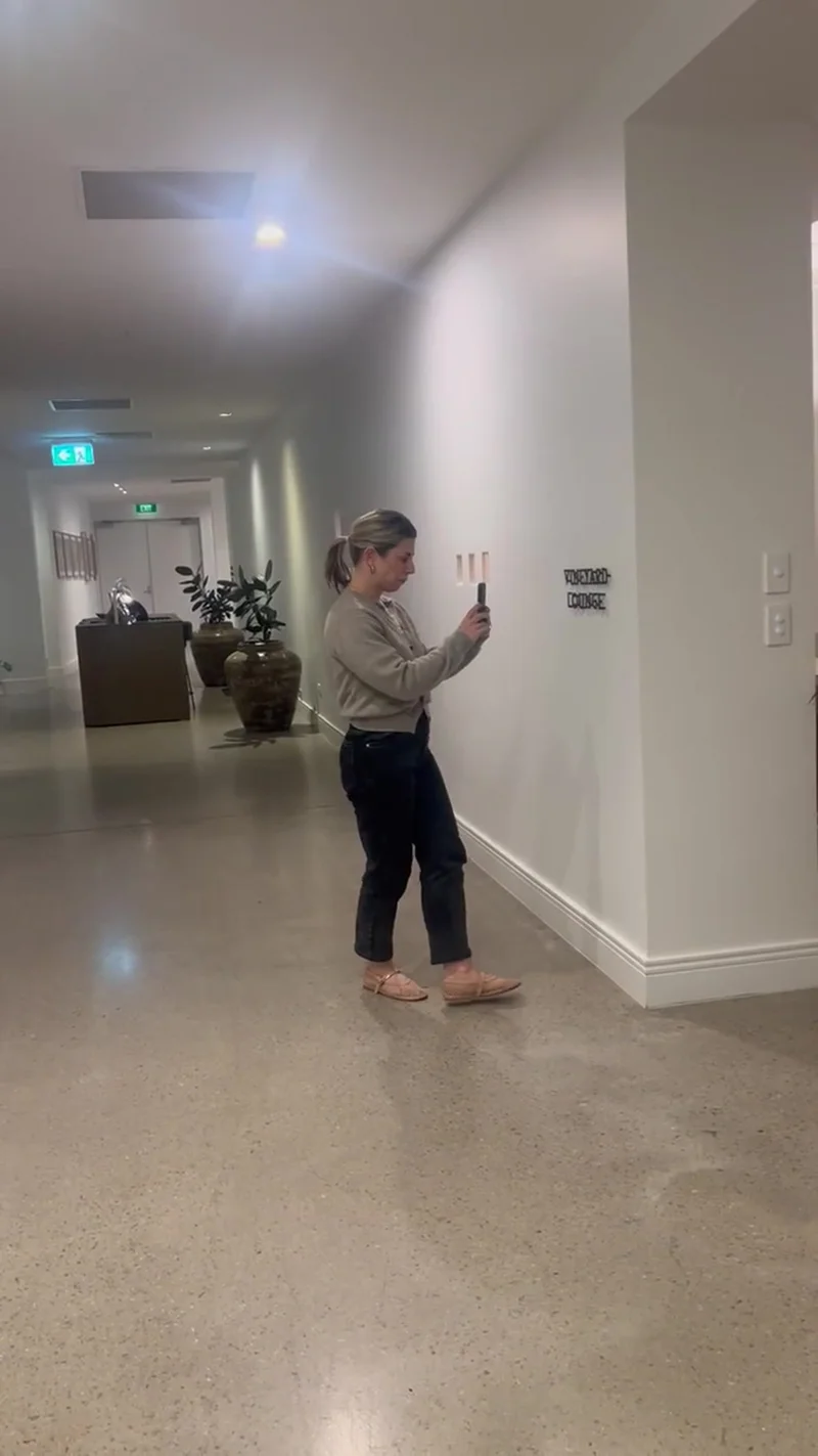 Daniella filming content on her phone